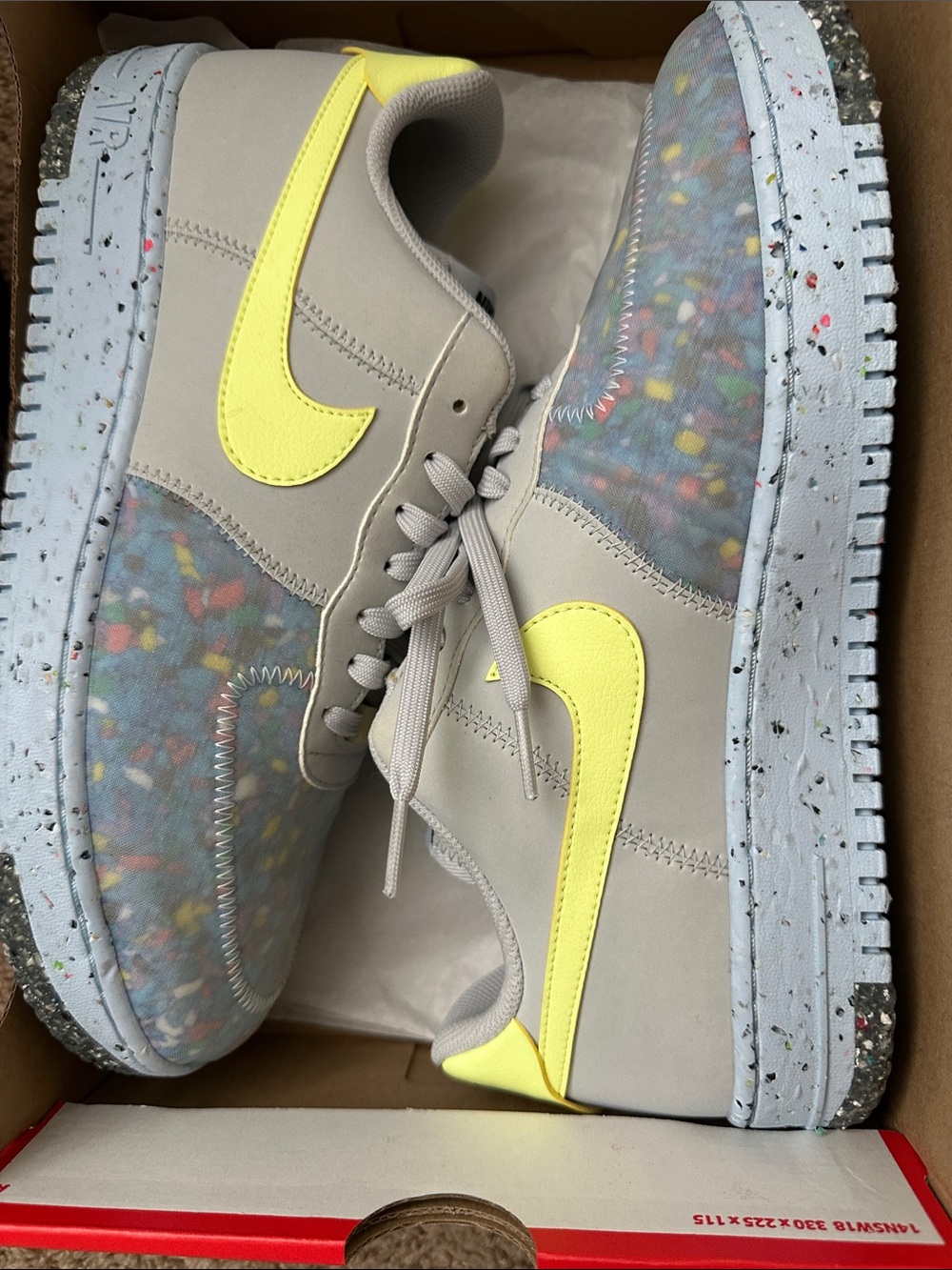Nike gray sneakers with neon yellow Swoosh and multicolor speckle